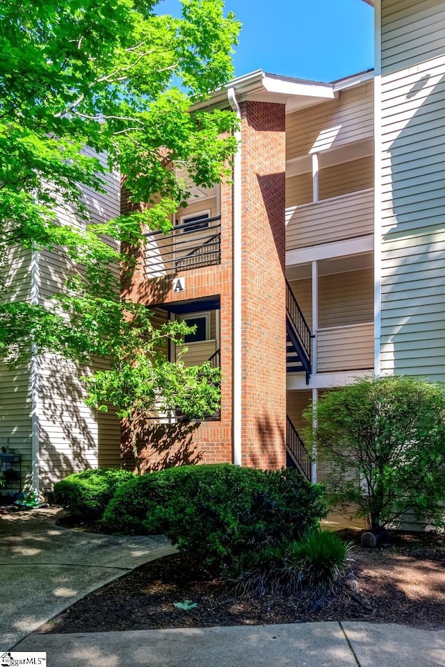 view of side of property with brick siding