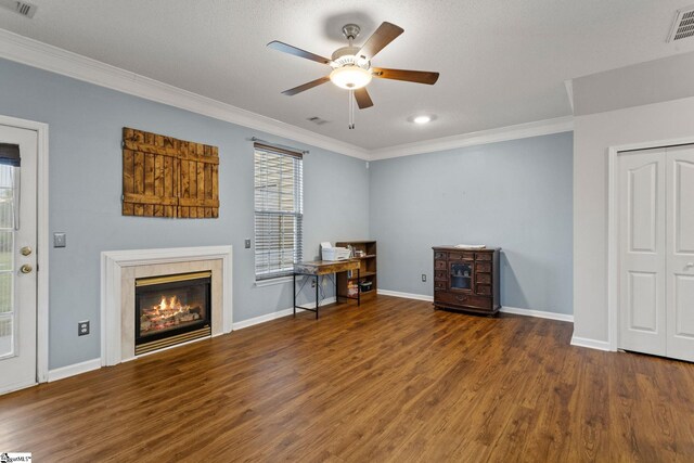 living room featuring crown molding, ceiling fan, wood finished floors, a fireplace, and baseboards