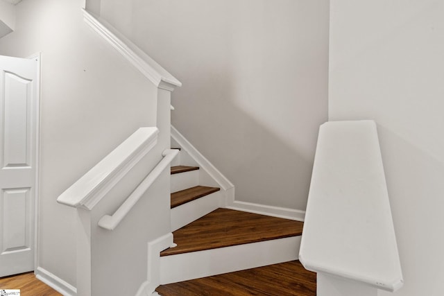 stairway with wood finished floors