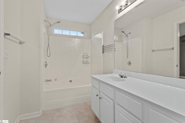 full bath featuring  shower combination, vanity, baseboards, and tile patterned floors