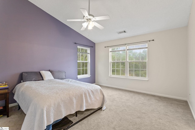bedroom featuring vaulted ceiling, carpet floors, baseboards, and a ceiling fan