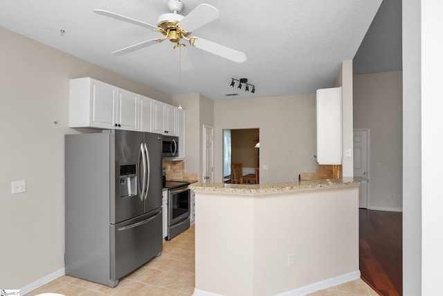 325 Waterton Way, Simpsonville, SC 29680 - kitchen featuring stainless steel appliances, white cabinets, light stone countertops, a ceiling fan, and a peninsula