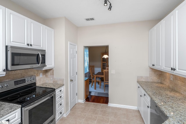 325 Waterton Way, Simpsonville, SC 29680 - kitchen featuring appliances with stainless steel finishes, baseboards, light stone counters, and white cabinets