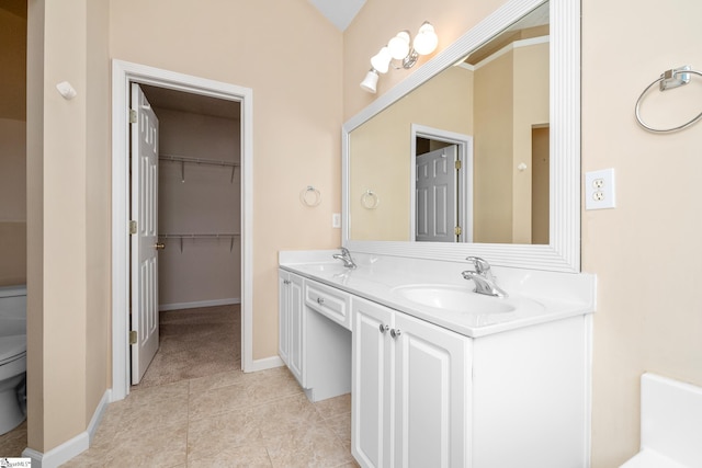 325 Waterton Way, Simpsonville, SC 29680 - bathroom with toilet, tile patterned floors, double vanity, baseboards, and a walk in closet