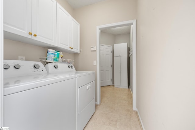 325 Waterton Way, Simpsonville, SC 29680 - laundry room with washing machine and clothes dryer, cabinet space, light tile patterned floors, and baseboards