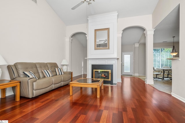 325 Waterton Way, Simpsonville, SC 29680 - living room with ceiling fan, arched walkways, wood finished floors, a glass covered fireplace, and decorative columns