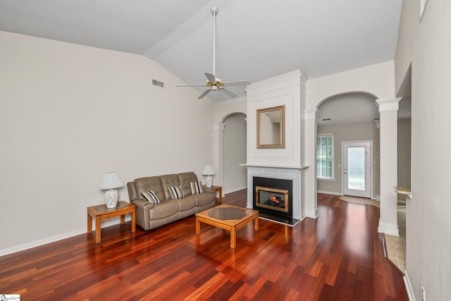 325 Waterton Way, Simpsonville, SC 29680 - living room featuring wood finished floors, ceiling fan, vaulted ceiling, arched walkways, and a lit fireplace