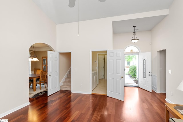 325 Waterton Way, Simpsonville, SC 29680 - foyer entrance featuring a high ceiling, wood finished floors, arched walkways, a ceiling fan, and stairway