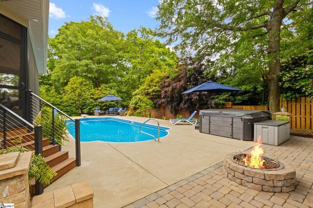 6 Pebble Stone Ln, Taylors, SC 29687 - view of swimming pool with a patio, a fire pit, a hot tub, fence, and view of scattered trees