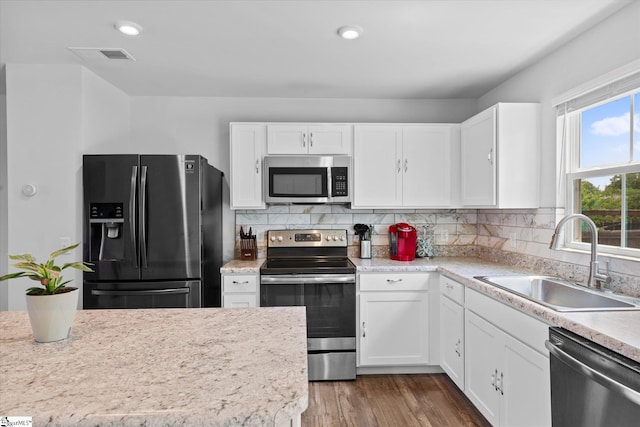 204 Maplestead Farms Ct, Greenville, SC 29617 - kitchen with stainless steel appliances, a sink, white cabinetry, light countertops, and decorative backsplash