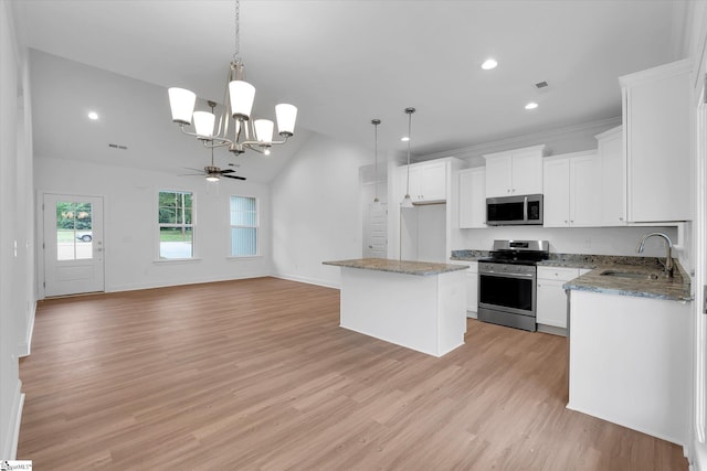 107A W Stewart St, Pelzer, SC 29669 - kitchen with stainless steel appliances, a sink, vaulted ceiling, a chandelier, and light wood finished floors