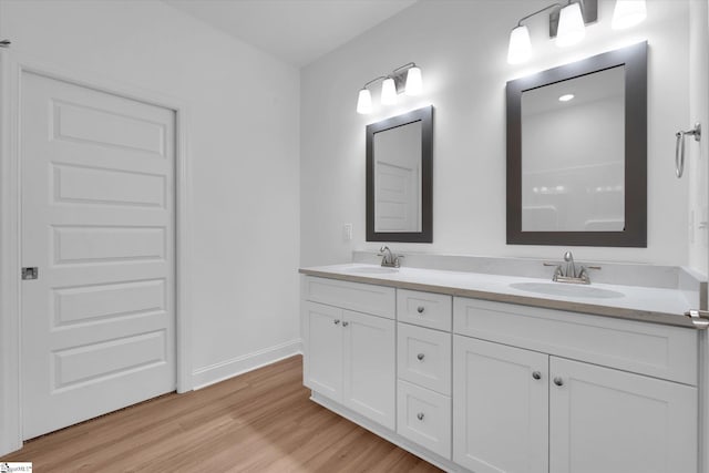 107A W Stewart St, Pelzer, SC 29669 - bathroom featuring wood finished floors, double vanity, and baseboards