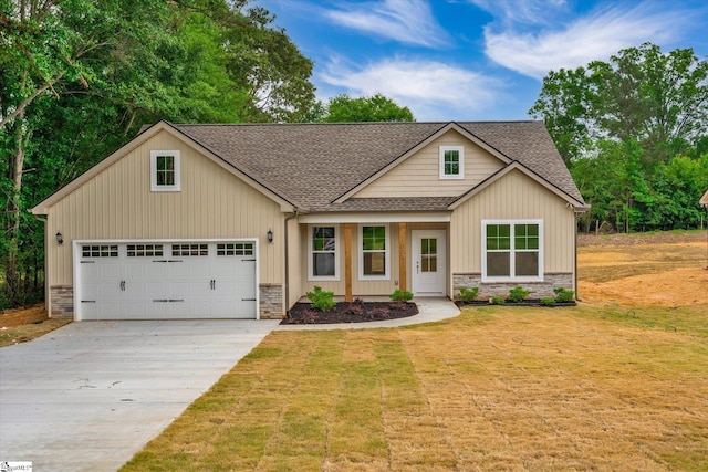 107A W Stewart St, Pelzer, SC 29669 - view of front facade with roof with shingles, stone siding, driveway, and a front yard