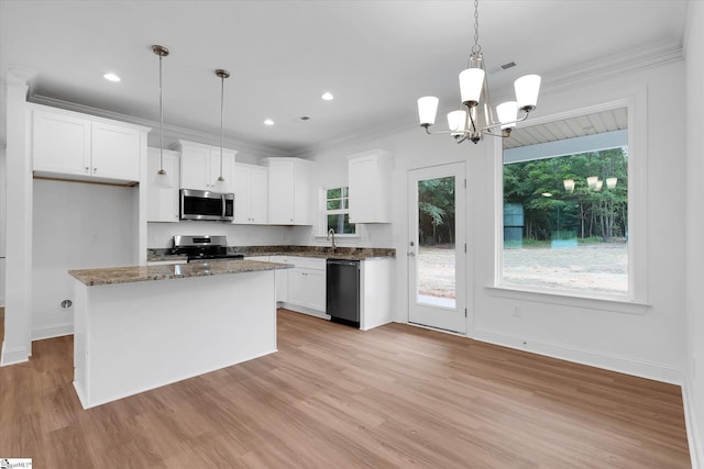 107A W Stewart St, Pelzer, SC 29669 - kitchen featuring appliances with stainless steel finishes, white cabinetry, light wood-style flooring, ornamental molding, and a chandelier
