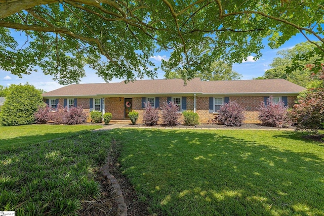 ranch-style house with a front lawn and brick siding