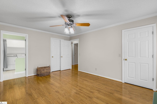 unfurnished bedroom with light wood-style floors, ornamental molding, a textured ceiling, baseboards, and ensuite bath