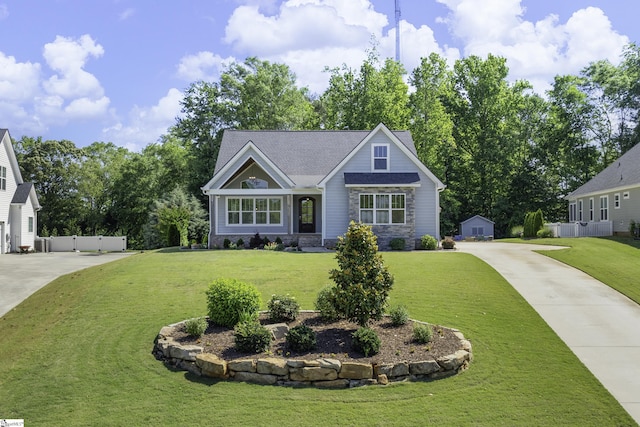 216 Saddle Creek Ct, Greer, SC 29651 - view of front of house featuring driveway, stone siding, and an outbuilding