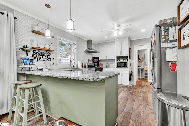 103 Mississippi Dr, Clinton, SC 29325 - kitchen with appliances with stainless steel finishes, ornamental molding, wall chimney range hood, a peninsula, and a sink