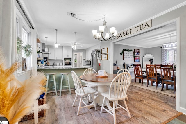 103 Mississippi Dr, Clinton, SC 29325 - dining area featuring a chandelier, a ceiling fan, light wood-style floors, healthy amount of natural light, and crown molding