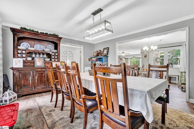 103 Mississippi Dr, Clinton, SC 29325 - dining room featuring crown molding, wood finished floors, and a chandelier