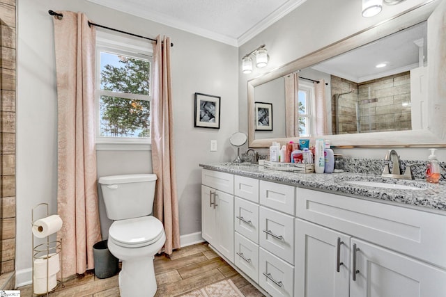 103 Mississippi Dr, Clinton, SC 29325 - full bathroom featuring baseboards, ornamental molding, a tile shower, wood finished floors, and double vanity