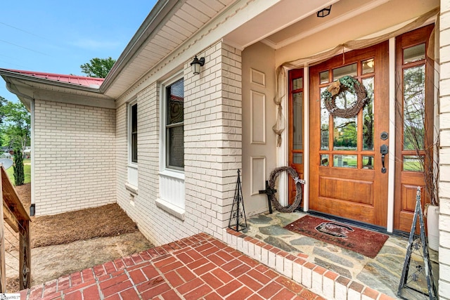 103 Mississippi Dr, Clinton, SC 29325 - view of exterior entry featuring brick siding, metal roof, and covered porch