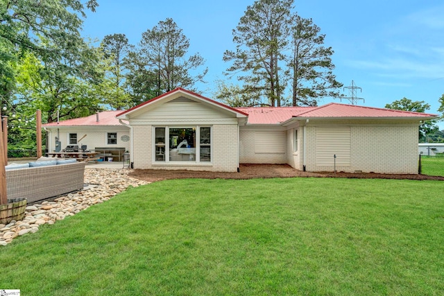 103 Mississippi Dr, Clinton, SC 29325 - back of house with a lawn, metal roof, brick siding, and an outdoor hangout area