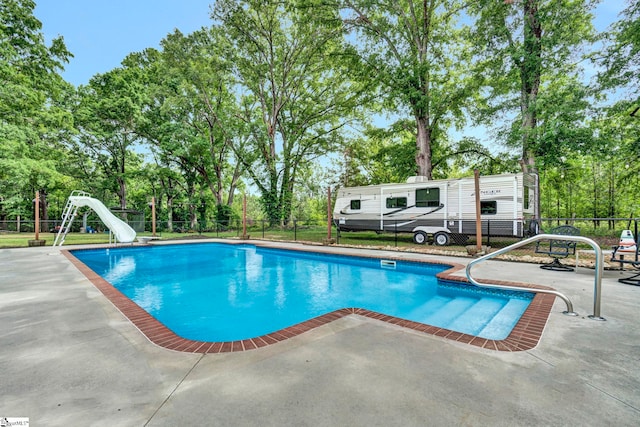 103 Mississippi Dr, Clinton, SC 29325 - view of pool with a water slide, a patio area, fence, and view of wooded area