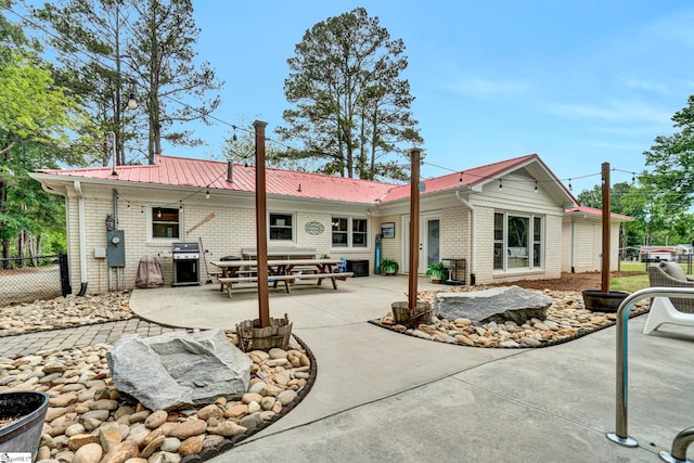 103 Mississippi Dr, Clinton, SC 29325 - rear view of house featuring brick siding, fence, a patio, and metal roof