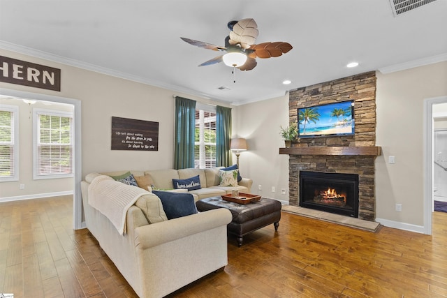 101 Belgian Blue Way, Fountain Inn, SC 29644 - living area with crown molding, wood-type flooring, a stone fireplace, ceiling fan, and baseboards