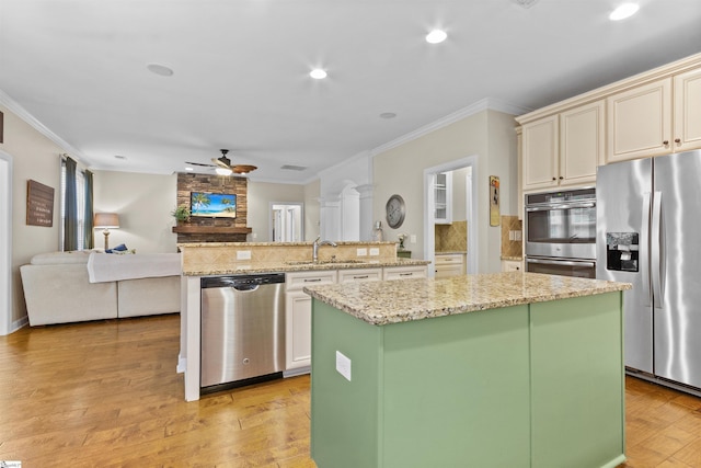 101 Belgian Blue Way, Fountain Inn, SC 29644 - kitchen featuring appliances with stainless steel finishes, a center island, a sink, crown molding, and ceiling fan