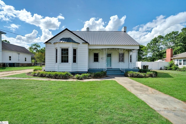 305 N Adair St, Clinton, SC 29325 - view of front of home featuring a porch, metal roof, and a chimney
