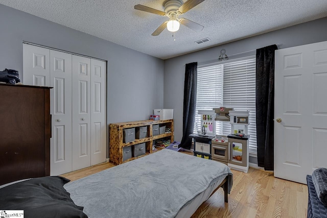 221 Twin Falls Dr, Simpsonville, SC 29680 - bedroom featuring light wood-style flooring, a closet, a textured ceiling, and a ceiling fan