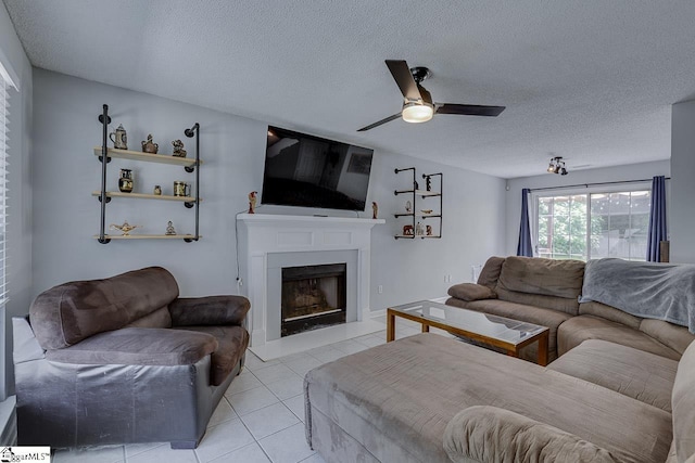 221 Twin Falls Dr, Simpsonville, SC 29680 - living room with ceiling fan, light tile patterned floors, a fireplace with raised hearth, and a textured ceiling
