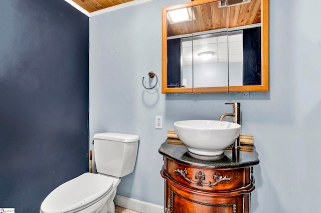 bathroom with toilet, baseboards, vanity, and wooden ceiling