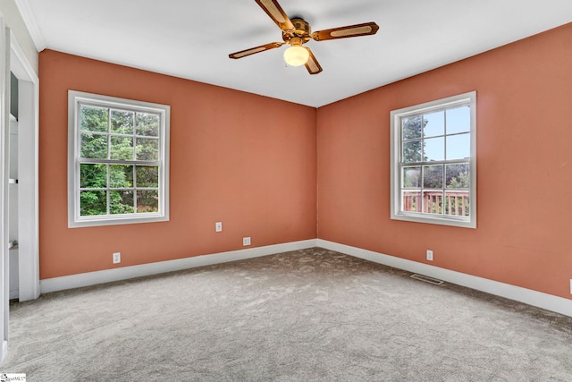 unfurnished room with baseboards, carpet flooring, and ceiling fan