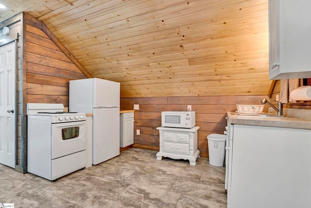 kitchen featuring white appliances, lofted ceiling, wooden walls, white cabinets, and wooden ceiling