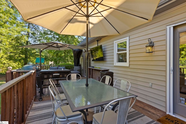 wooden terrace with outdoor dining space