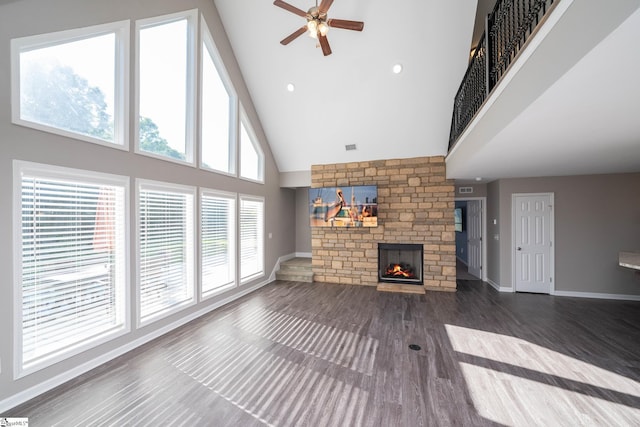 221 Wilsontown Rd, Laurens, SC 29360 - unfurnished living room featuring high vaulted ceiling, a large fireplace, a ceiling fan, baseboards, and wood finished floors