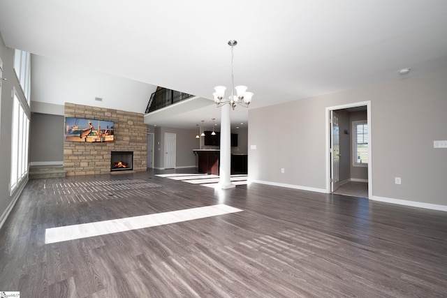 221 Wilsontown Rd, Laurens, SC 29360 - unfurnished living room with a fireplace, a chandelier, wood finished floors, and baseboards