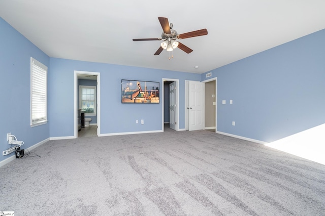 221 Wilsontown Rd, Laurens, SC 29360 - unfurnished bedroom featuring a walk in closet, carpet, baseboards, and ceiling fan
