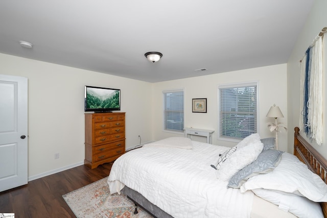 bedroom with wood finished floors and baseboards