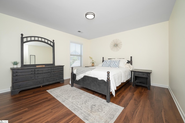 bedroom with wood finished floors and baseboards