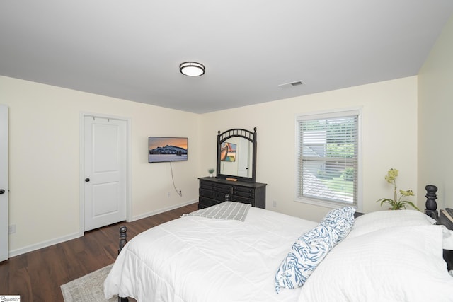bedroom featuring wood finished floors and baseboards