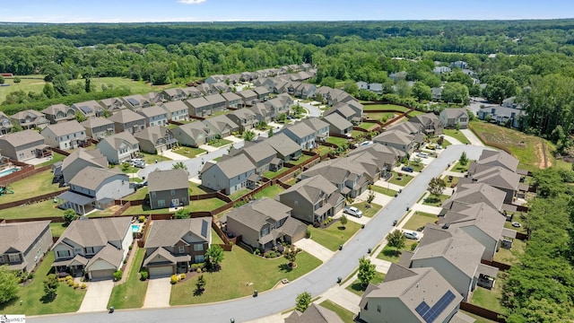 aerial overview of property's location with nearby suburban area and a forest