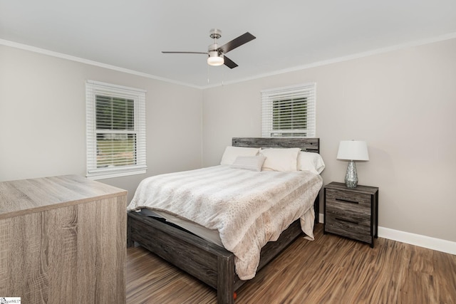 bedroom featuring crown molding, wood finished floors, baseboards, and ceiling fan