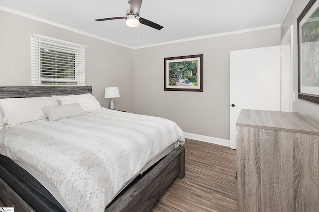 bedroom with wood finished floors, baseboards, crown molding, and a ceiling fan