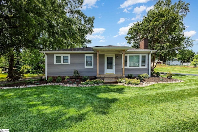 single story home featuring a chimney and a front yard
