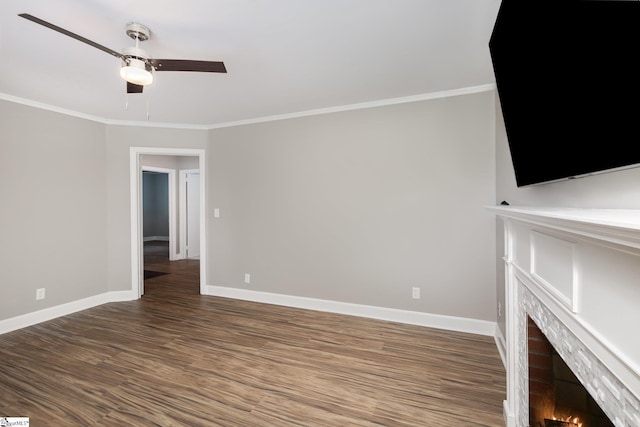 unfurnished living room featuring ceiling fan, baseboards, wood finished floors, and crown molding