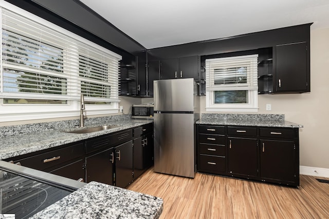 kitchen with appliances with stainless steel finishes and dark cabinetry